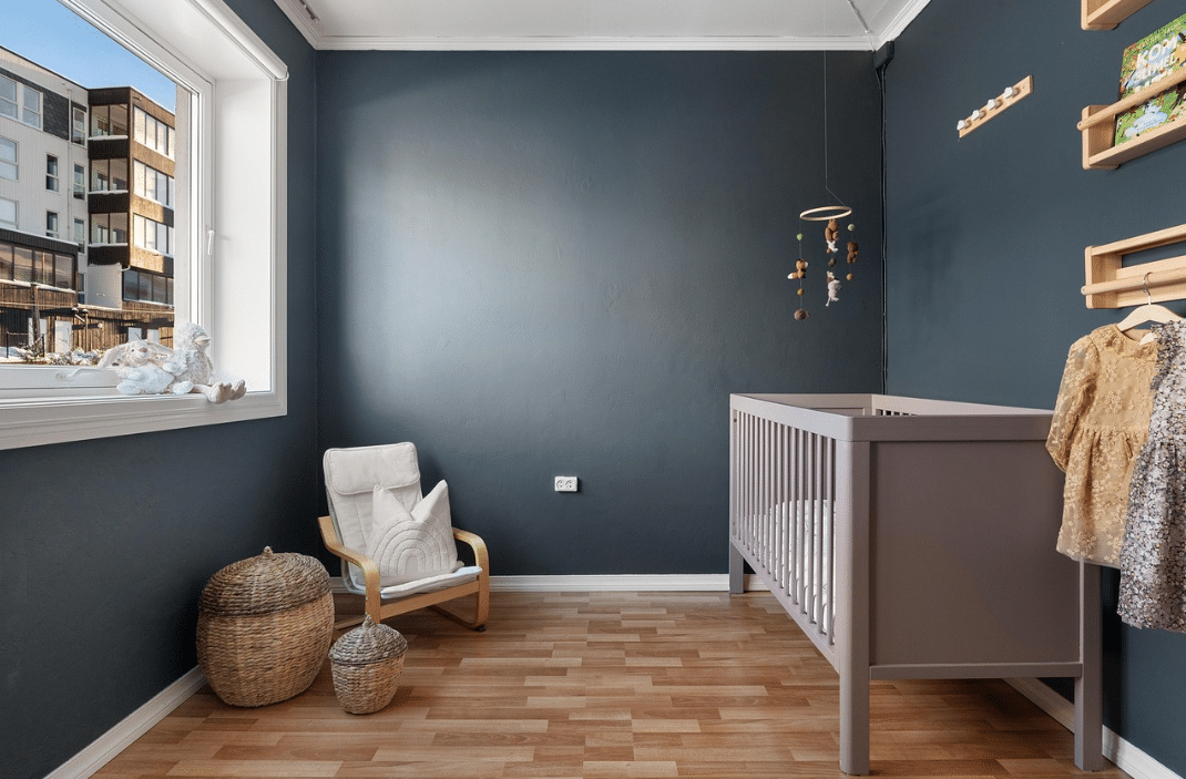 nursery with gray walls and hardwood floor