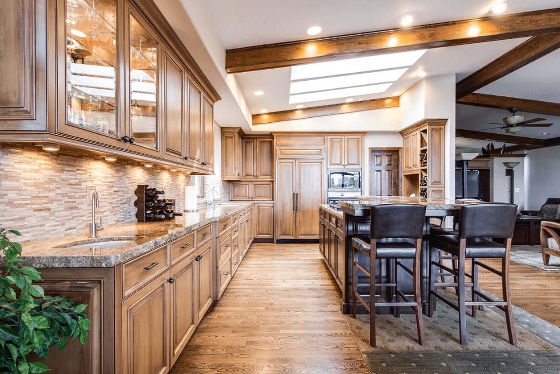 kitchen wood flooring and cabinets with dining table